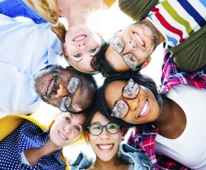 Group of Multi Ethnic Casual People with their Heads Together Showing Friendship